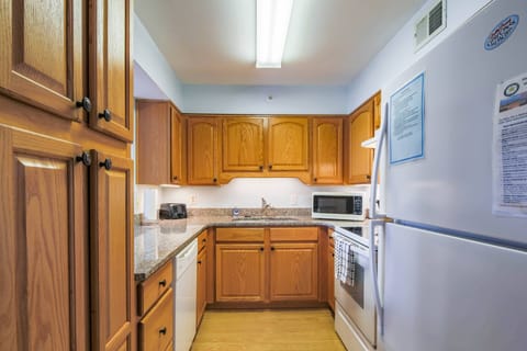 The kitchen is stocked with an electric range, dishwasher, microwave, refrigerator and toaster.