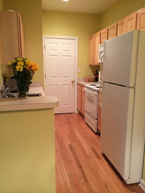 full kitchen with one cup Kurig coffee maker, microwave and toaster.