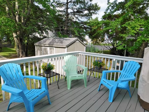 451 D Garfield Parkway - Teal Adirondack Deck - Raised wooden deck featuring teal and light green Adirondack-style lounge chairs.
