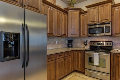 Fully stocked gourmet kitchen featuring stainless steel appliances