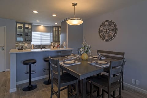 Spacious dining area seats 6 with additional seating at breakfast bar.