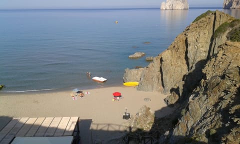 Nice sandy bays at Masua,   Porto Flavia, just 20 mins from San Benedetto.