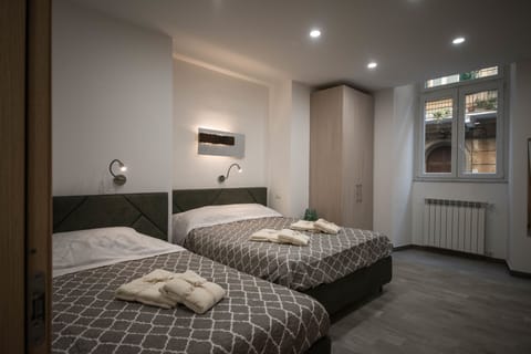 Comfort Quadruple Room | Memory foam beds, in-room safe, individually furnished, desk