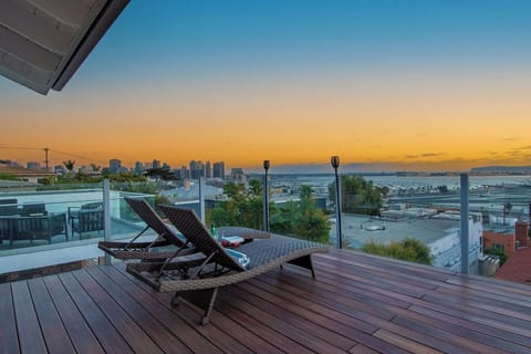 Relax in style on the deck, featuring comfortable lounge chairs perfect for soaking up the coastal breeze.