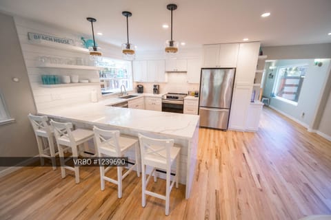 New, well-stock kitchen seats four at the island and has plenty of room to cook.