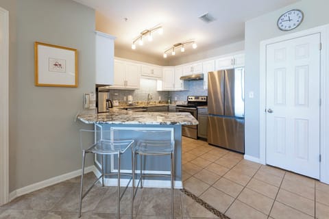 Enjoy cooking in this stylish kitchen featuring granite countertops, stainless steel appliances, and modern lighting
