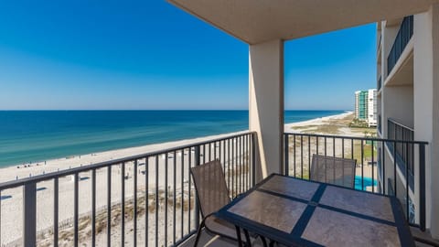 Enjoy meals or drinks at the outdoor table while taking in expansive views of the tranquil waters and beach below