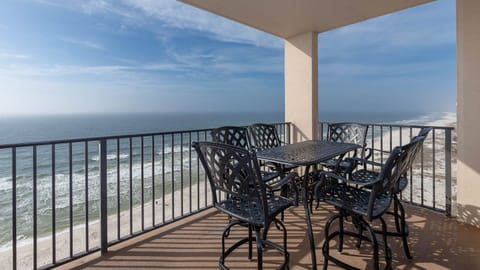 Savor meals or drinks at the outdoor patio set while enjoying expansive views of the waves from the top floor