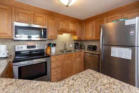 Cook and gather in this functional kitchen featuring stainless steel appliances and ample counter space for meal prep