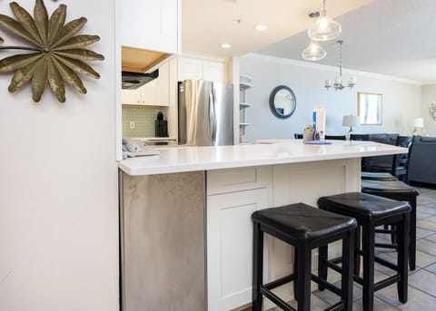 Enjoy casual meals at the sleek kitchen bar with seating for four, perfect for gathering and conversation