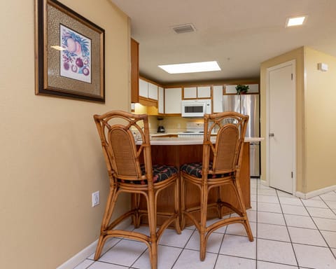 Gather around the stylish bar stools at the kitchen counter, perfect for casual meals and morning coffee