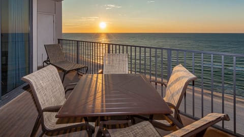 Watch the sun rise over the water while enjoying a meal at the outdoor table surrounded by comfortable seating
