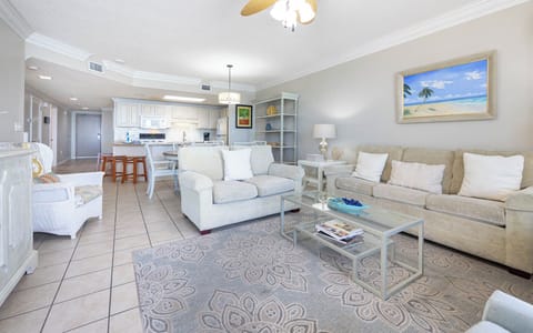 Inviting living area featuring a sofa with queen sleeper, a stylish coffee table, and a view of the open kitchen