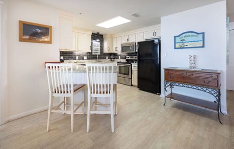 Enjoy meals or coffee at the stylish breakfast bar, surrounded by a elegant kitchen and inviting decor