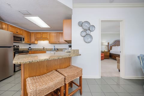 Enjoy cooking in the spacious kitchen with a breakfast bar, leading to a cozy living area and inviting master bedroom