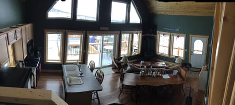 Panorama of great room and kitchen from the loft stairs