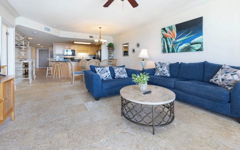 Relax on the cozy blue sofa, surrounded by tasteful decor and a warm atmosphere perfect for unwinding