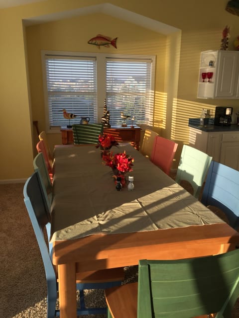 10 person dining table with colorful chairs.