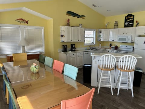 An open floor plan.  Breakfast bar to the left.  (The top is now white quartz)