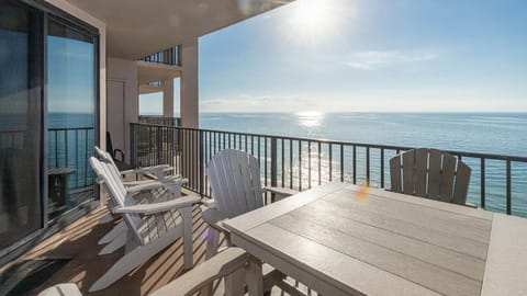 Enjoy the fresh air while seated at the table or in comfortable chairs, soaking in the expansive beach views