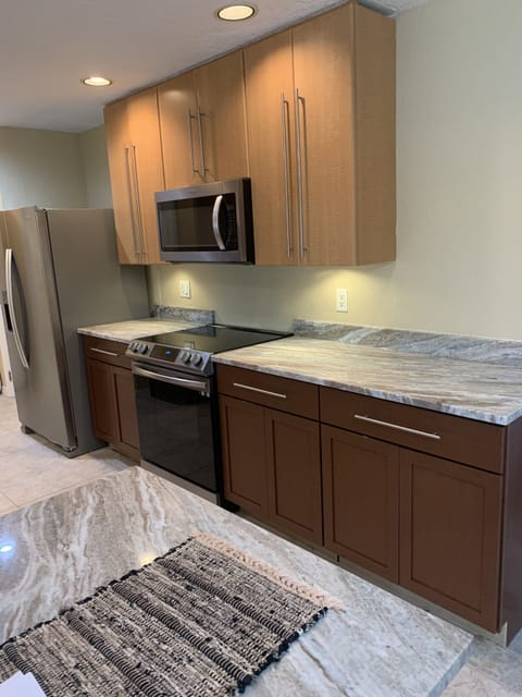 The gourmet kitchen has updated stainless steel appliances and new cupboards.