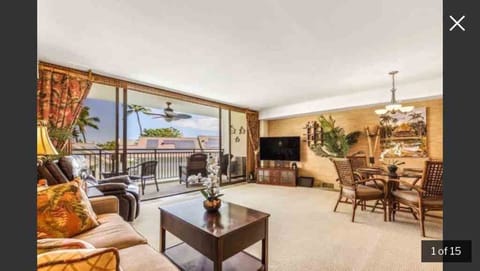 Open living room to beautiful lanai with peek-a-boo ocean views
