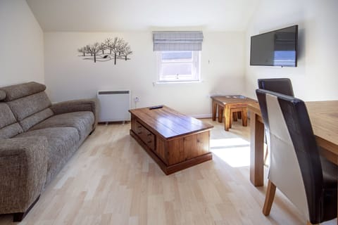 Apartment, 1 Bedroom | Living area | Flat-screen TV, DVD player