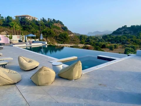 Seasonal outdoor pool, open 10:00 AM to 8:00 PM, pool umbrellas