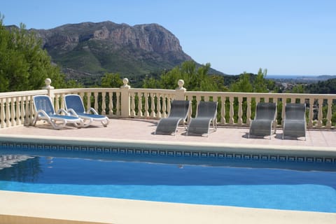 Pool surrounded by terracing with great views.
