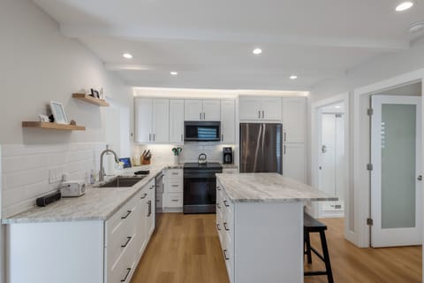 Fully-stocked kitchen with induction stove, microwave, dishwasher, great fridge.