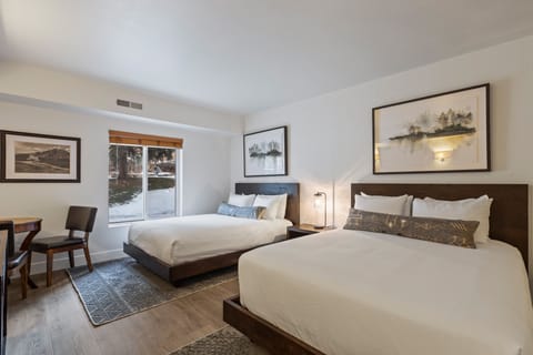 This is a beautiful hotel style room that offers two queen size beds and well-appointed furniture.