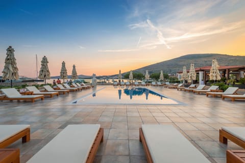 Seasonal outdoor pool, open 9:00 AM to 7:00 PM, pool umbrellas