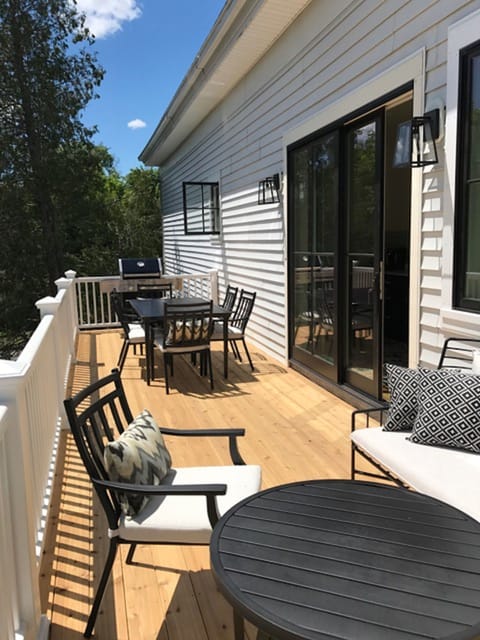 Outdoor space: large deck with grill, dining and seating area