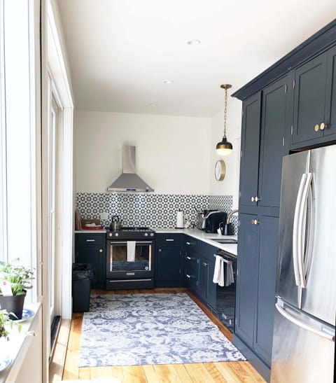 Full kitchen with KitchenAid range, fridge, DW, MW, large sink, marble counters