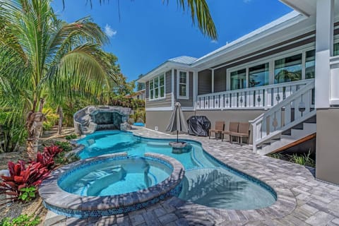 Heated outdoor pool with a spa, slide and waterfall feature
