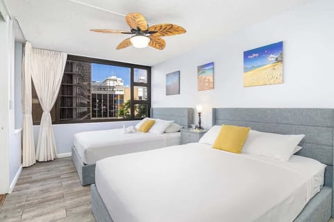 Bedroom with 2 queen-size beds and ceiling fan for air circulation