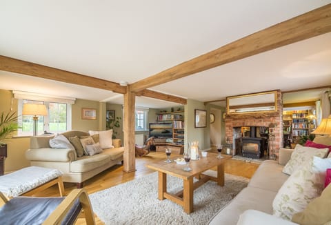 Ground floor: Spacious sitting room with dual sided wood burning stove