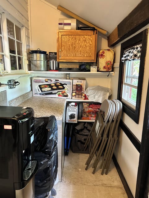 Storage area w/5gal. water cooler, small appliances and access to the back yard.