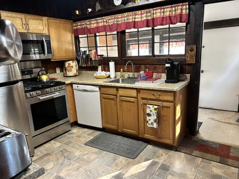 Our kitchen with a small storage area, back yard access and a view of the pond.