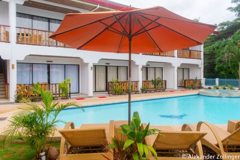 Outdoor pool, open 7 AM to 10 PM, pool umbrellas, sun loungers