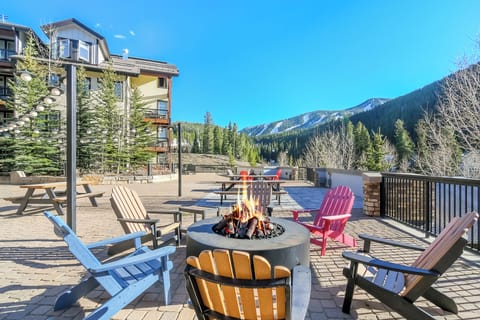 Shared Amenity Deck  fire pit patio surrounded by colorful Adirondack chairs and dramatic alpine views.