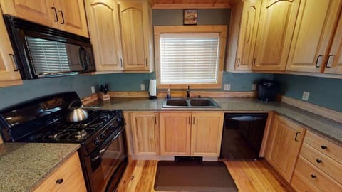 This kitchen is equipped with everything you might need to cook a home cooked meal.