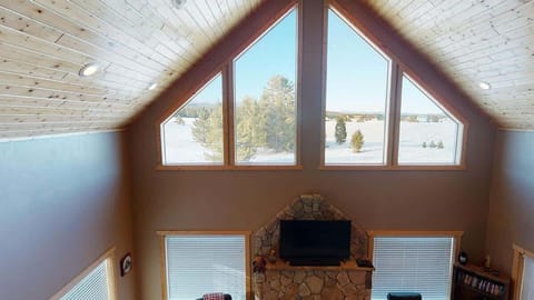 Natural light pours in through large windows, tying it all together with a view of the forest just beyond.