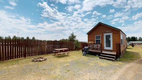 This Tiny house cabin blends rustic charm with modern amenities, nestled within the serene forested landscapes near Yellowstone National Park.