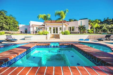 Gorgeous terra cotta style tiling surrounding pool.