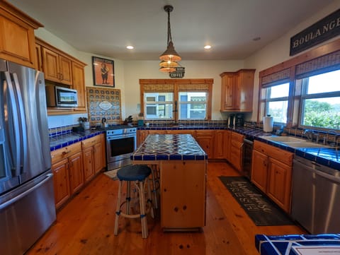 Rich hardwood floors in the full size kitchen, complete with isl