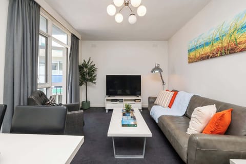 Comfy separate living room with leather sofa and occassional chair