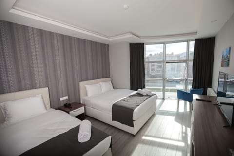 Family Triple Room, Smoking | Premium bedding, minibar, in-room safe, desk