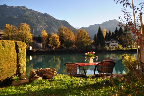 Private garden with BBQ and seating for 4 directly located on the River Aare.