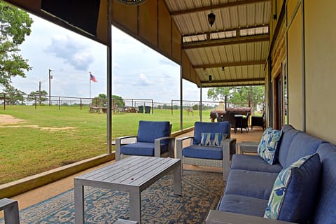 Large patio with tv and large smoker pit